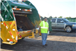 Volunteer Standing by Trash Truck