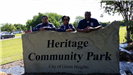 Volunteers by the Heritage Community Park Sign