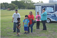 Family Standing In Front of a Trailer