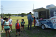 Kids in Line at a Snowcone Trailer