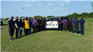 Volunteers in Front of a Police Car