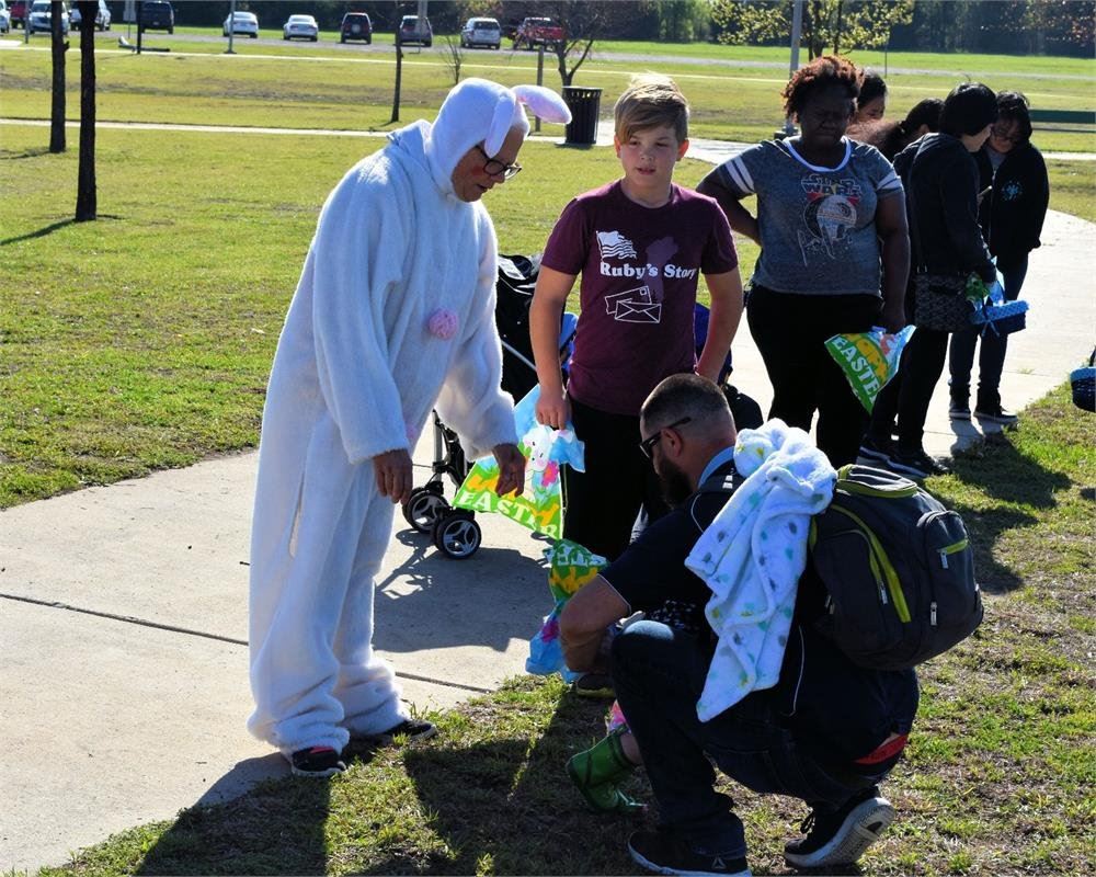 Women in an Easter Bunny Costumer Talking to Kids