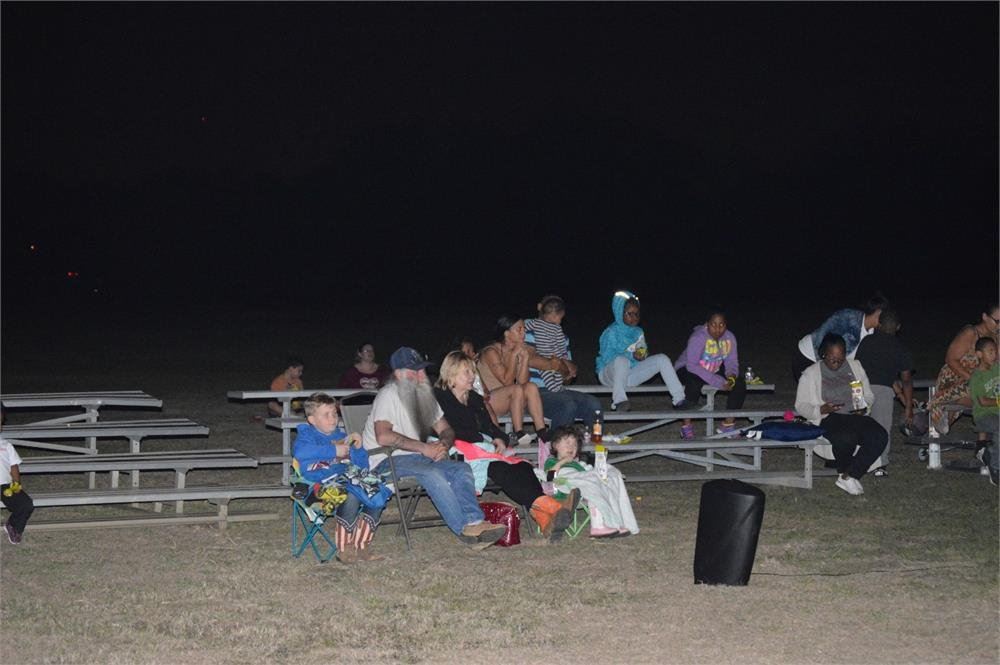Kids and adults Sitting in Lawn Chairs and Bleachers