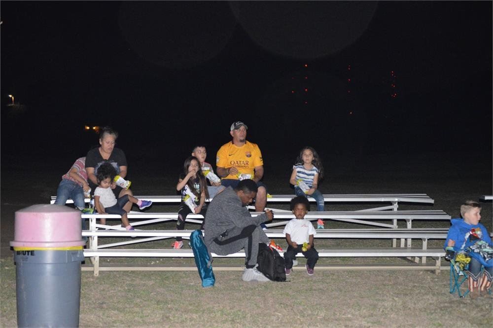 Kids and Adults Sitting on Bleachers