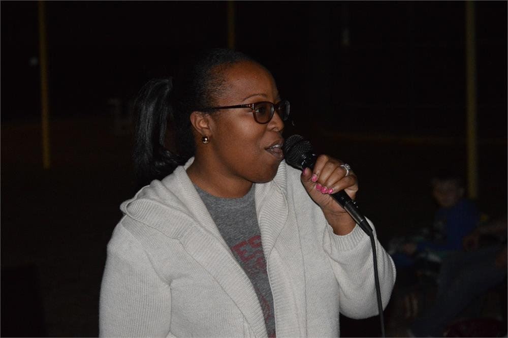 Woman Talking into a Microphone
