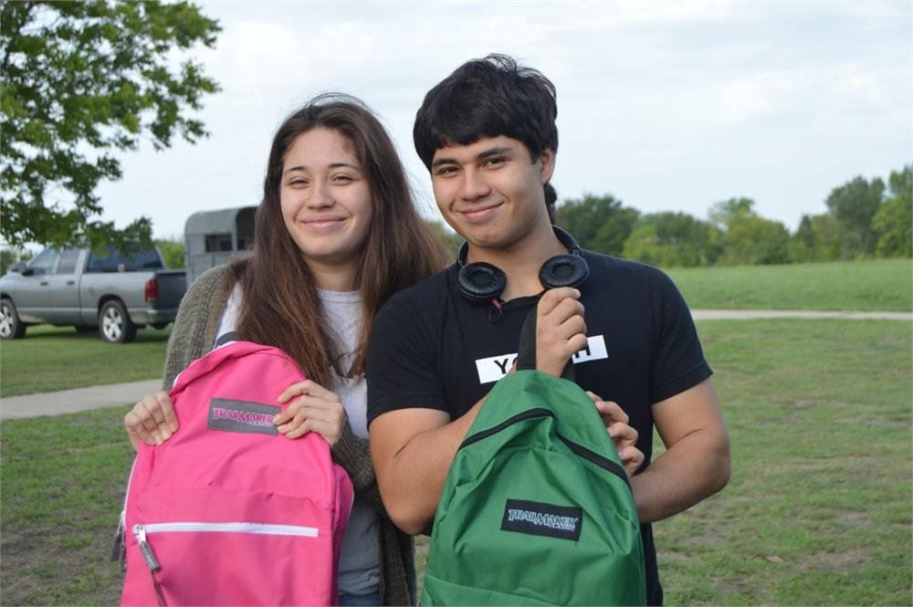 Two Teens Holding Backpacks