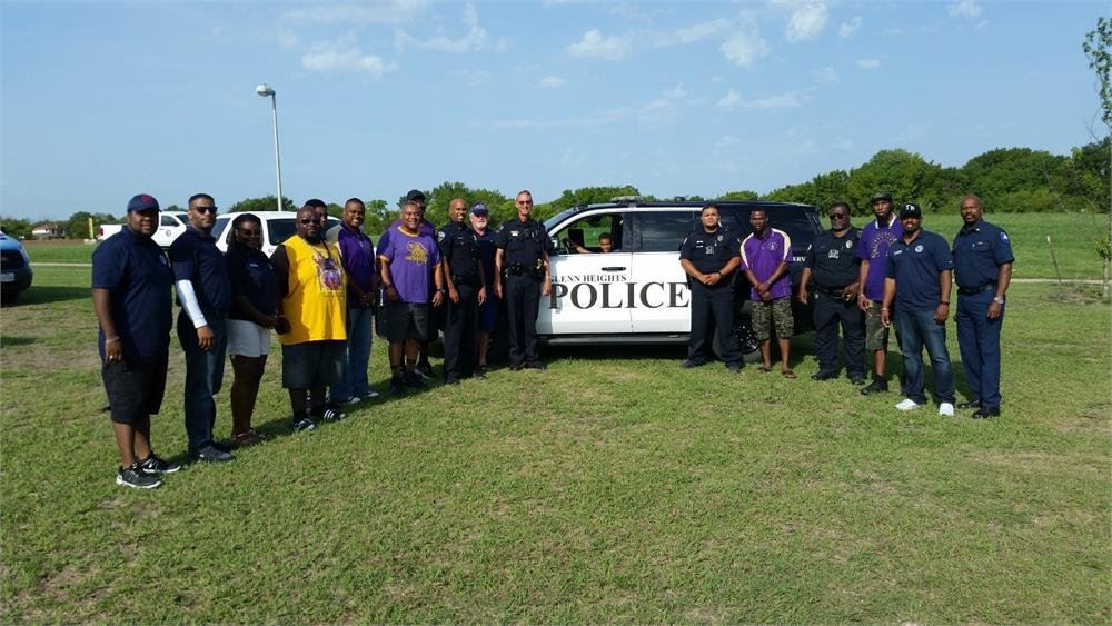 Volunteers in Front of a Police Car