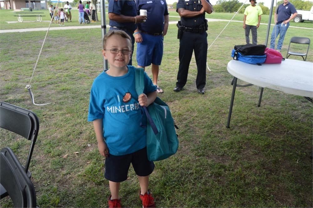 Young Boy Holding a Backpack