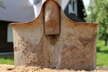 Rusty Shovel Breaking into the Ground